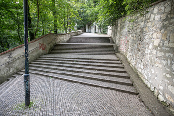 Winding staircase on Petrin Hill in Prague surrounded by lush greenery. Visitors can enjoy a...