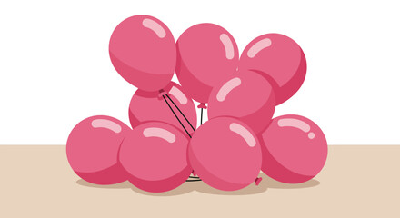 Fototapeta premium A cluster of bright pink balloons tied together with a silver string on a light brown surface