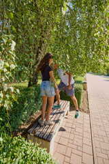 Father and daughter spending time together in the park exercising and relaxing.