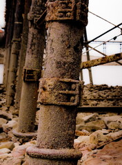 Close-up of weathered metal pillars in a dilapidated structure