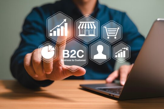 Person interacting with b to c icons on a digital interface near a laptop on a wooden surface