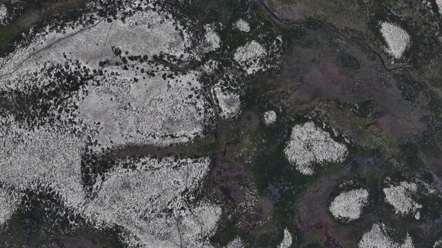 Aerial footage of the snow-dusted peaks and dark valleys in Rondane National Park, Norway
