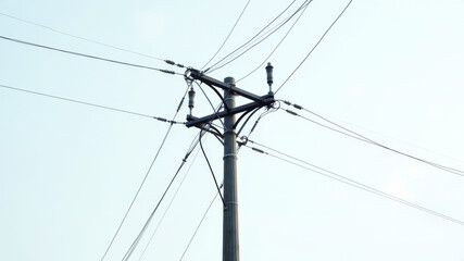 Electric wires and power lines crossing clear sky above urban tram route