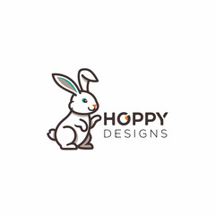 Fototapeta premium Cute rabbit sitting under a bush enjoying shade on a warm sunny afternoon in the countryside.