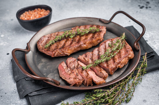 Roast Top blade steak, grilled beef shoulder meat. grey background. top view