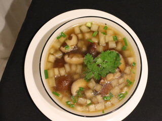Clear soup with shiitake mushrooms and daikon radish, a light and healthy Asian dish with a delicate flavor and comforting aroma.