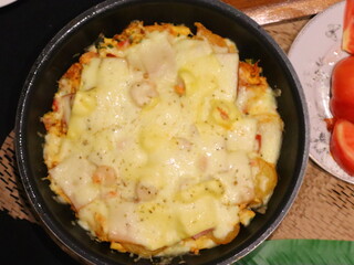 Double cheese pineapple pizza served in a hot pan, rich, cheesy, and delicious with a tropical twist.