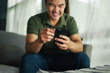 man using mobile phone holding cell phone texting message contact us.chatting,search internet...