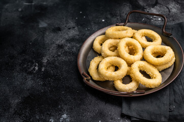 Ready for cooking Raw onion rings, uncooked vegetable. black background. top view