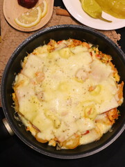 Double cheese pineapple pizza served in a hot pan, rich, cheesy, and delicious with a tropical twist.