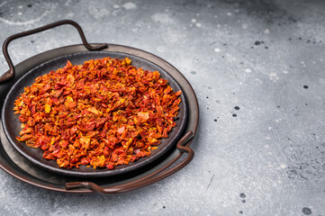 Dried Tomato Flakes, Indian and Arabic spices for cooking. grey background. top view