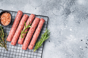 Raw beef and lamb meat kebabs sausages, kofta kebab. grey background. top view