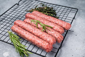 Raw beef and lamb meat kebabs sausages, kofta kebab. grey background. top view