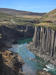 Explore the breathtaking beauty of Studlagil Canyon in Iceland filled with stunning basalt columns