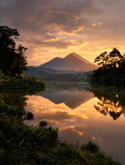 Tranquil Lake Reflecting Golden Mountain Landscape at Sunrise