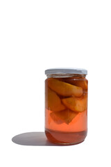 jar with preserved peaches in syrup on white background