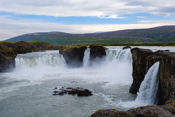 Majestic waterfalls cascading through rugged cliffs in Icelands natural beauty