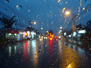 Rainy Car Windshield with City Lights Reflections at Night