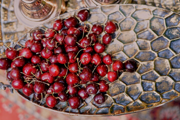 Cherries in large golden dishes Chic serving of dishes. Fruit