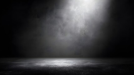 Dark concrete studio with bright spotlight illuminating textured wall and floor image