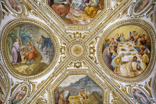 Salerno, Italy - 07 May 2025: View of the Duomo's ceiling frescoes, where golden frames encircle vibrant biblical scenes, creating a celestial mosaic of faith and artistry.
