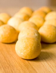 Round, light-yellow pastries on a wood surface