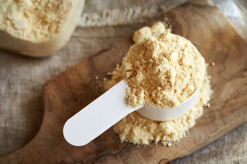 Whey protein powder in a white scoop