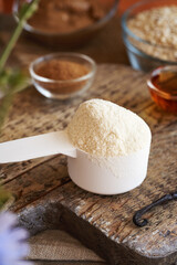 Whey protein powder, cinnamon, maple syrup, ground oat flakes and hazelnuts - ingredients for homemade protein bars