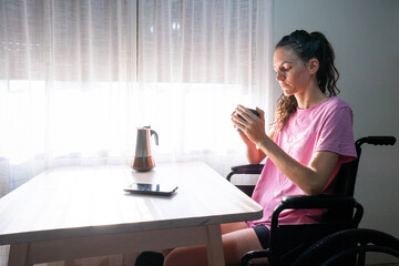Disabled woman enjoying morning coffee at home