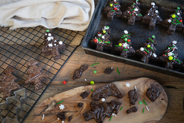 Chocolate brownie and ganache sandwiches decorated with colorful holiday sprinkles candies.
