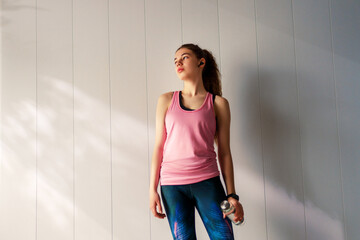 Woman in fashionable sportswear is doing exercise.