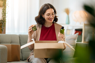 Woman is unpacking cardboard