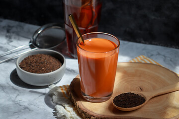 Traditional Thai tea brewing. Hot orange tea with condensed milk.