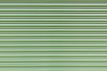 Obraz premium striped background of greenish interlocking lamellae