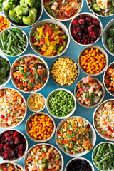 Various frozen veggies such as peas, carrots, and beans preserved in plates, a fresh and practical...
