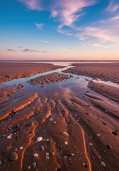Sunset Beach Landscape: Pink Sky, Rippled Sand, and Calm Waters