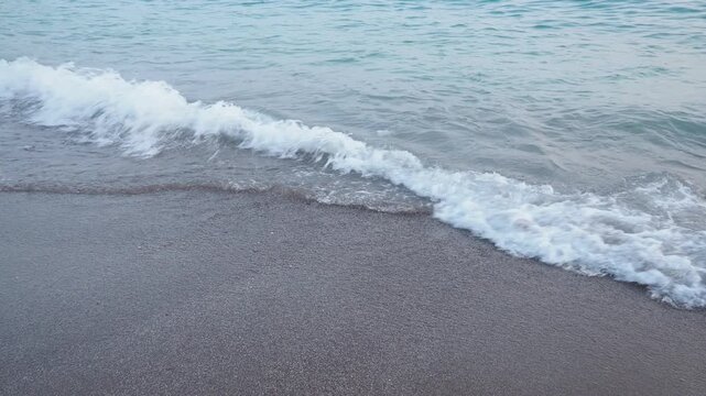 Waves softly lap against the sandy beach as the sun rises over the Mediterranean. Experience the serene beauty of Canj in Bar, Montenegro, where morning brings calmness and joy