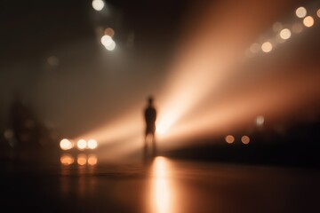 Fototapeta premium A hazy surreal image of a lone figure illuminated on stage evoking mystery and atmosphere
