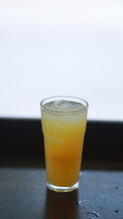 glass of bright yellow passion fruit juice