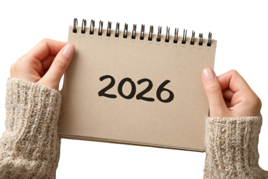 Hands holding a light brown notepad with the year 2026 written on it - Powered by Adobe