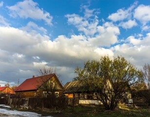 Rural houses under a cloudy sky