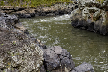 The river flows between the rocks