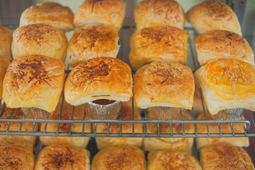 Bolen cake with grated cheese topping arranged on a display case