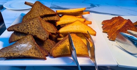 Sliced toast bread on a buffet table with white, whole grain, and dark options. Concept of...