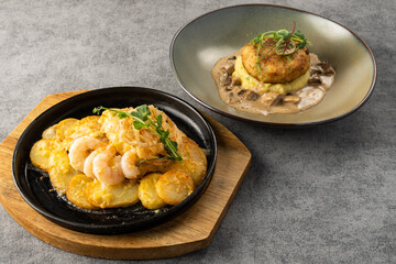 Gourmet seafood dish featuring grilled shrimp on a sizzling platter with golden potatoes, accompanied by a creamy mushroom risotto in an elegant bowl, showcasing culinary artistry