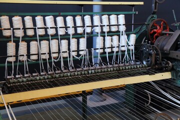 Textile factory machinery. Old loom machine. Historic textile industry.
