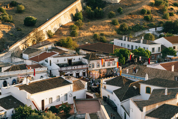 Spectators line the castle wall as performers dressed as knights entertain the audience below.