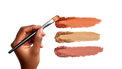 A hand holding a makeup brush, applying three shades of blush or eyeshadow