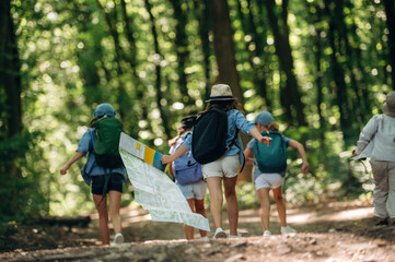 Happy kids are with tent in the forest