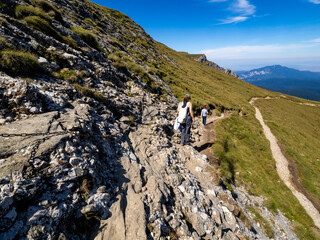 Tourists on the road to Heroes' Cross on Caraiman Peak, Romania